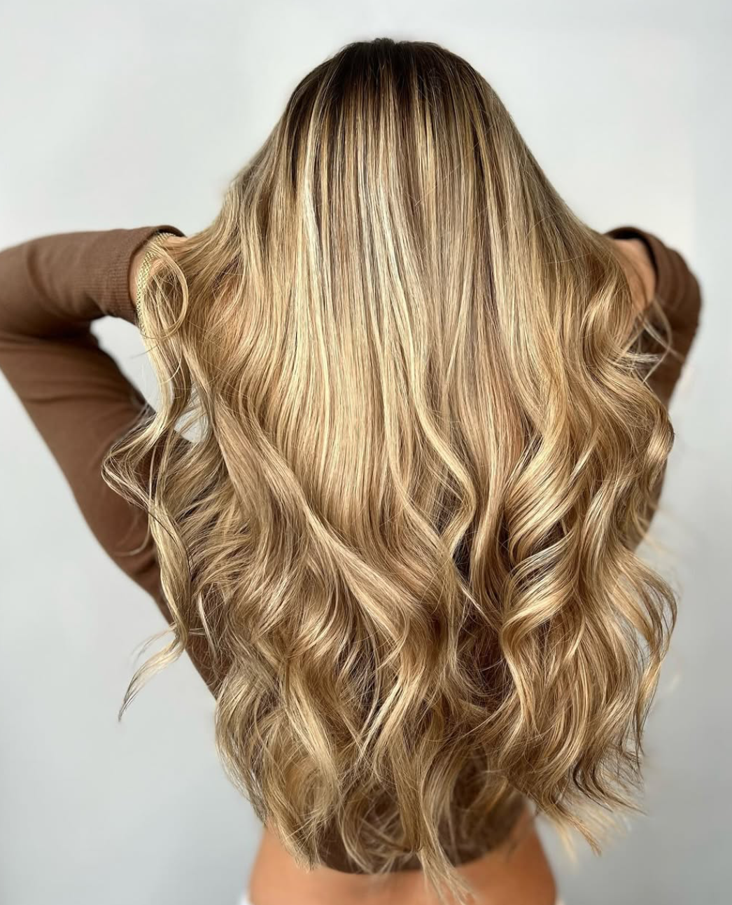 Rooted golden blonde balayage with voluminous curls